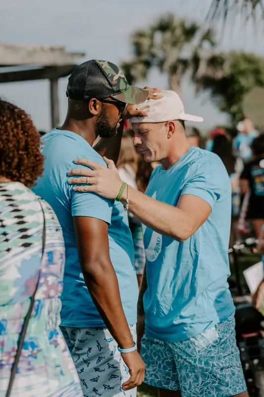 Men praying together in brotherhood