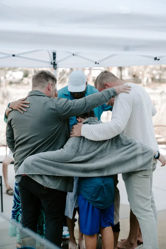 Group prayer huddle after baptism